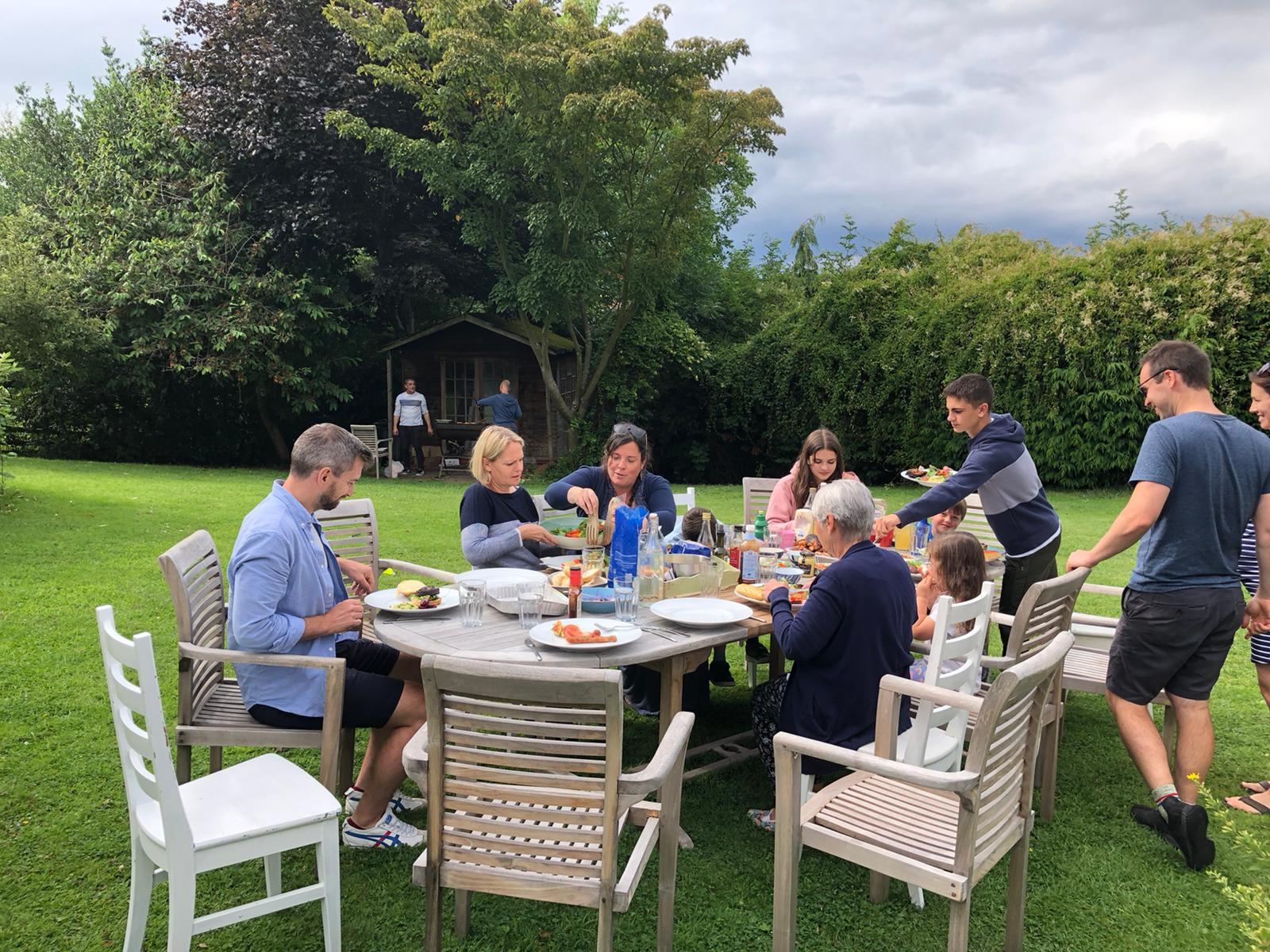 The family eating together outside